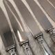 12 silver-plated metal dessert knives with rocaille ribbon decoration, 21.4 cm