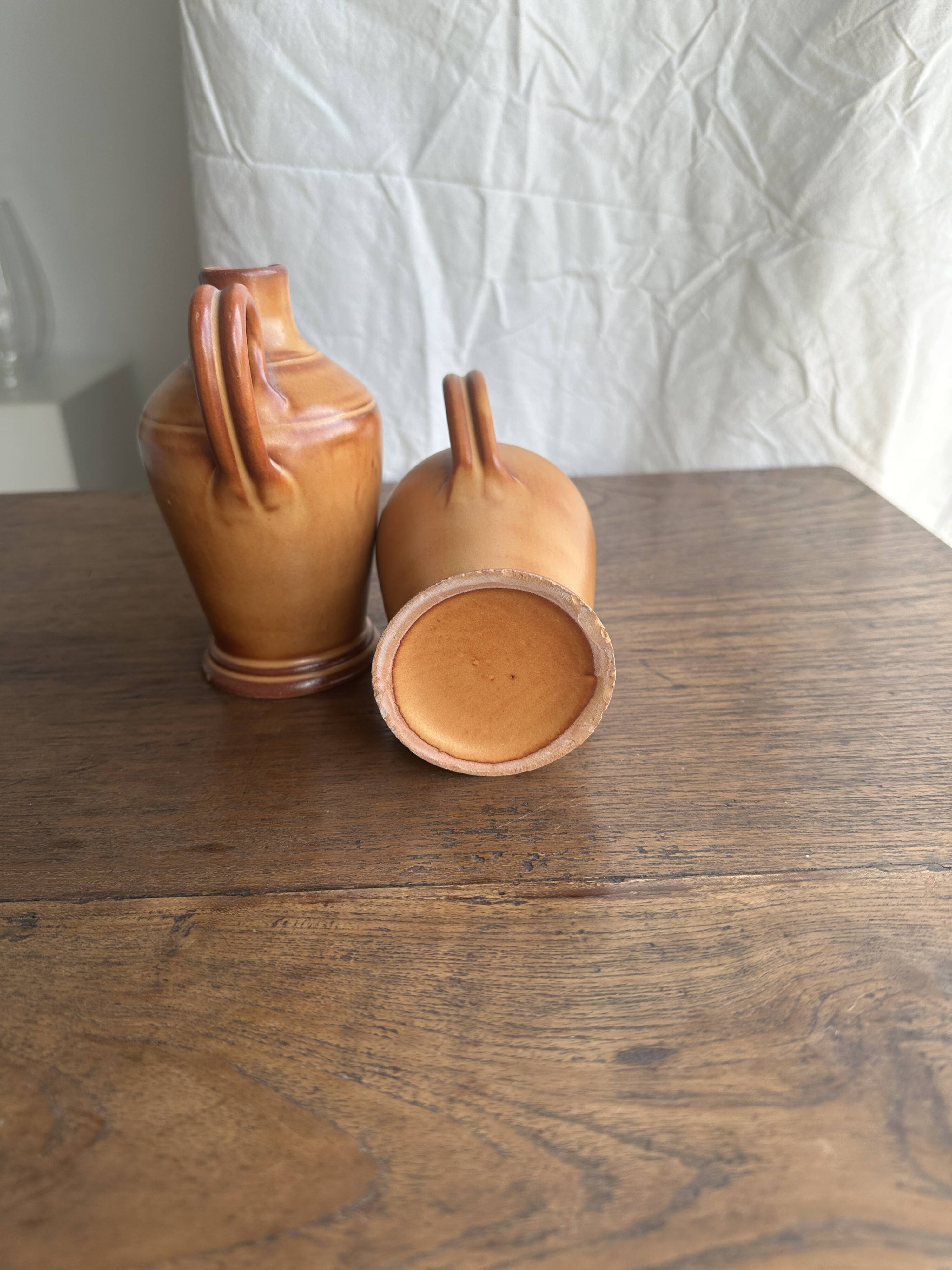 Pair of mini orange stoneware pitchers