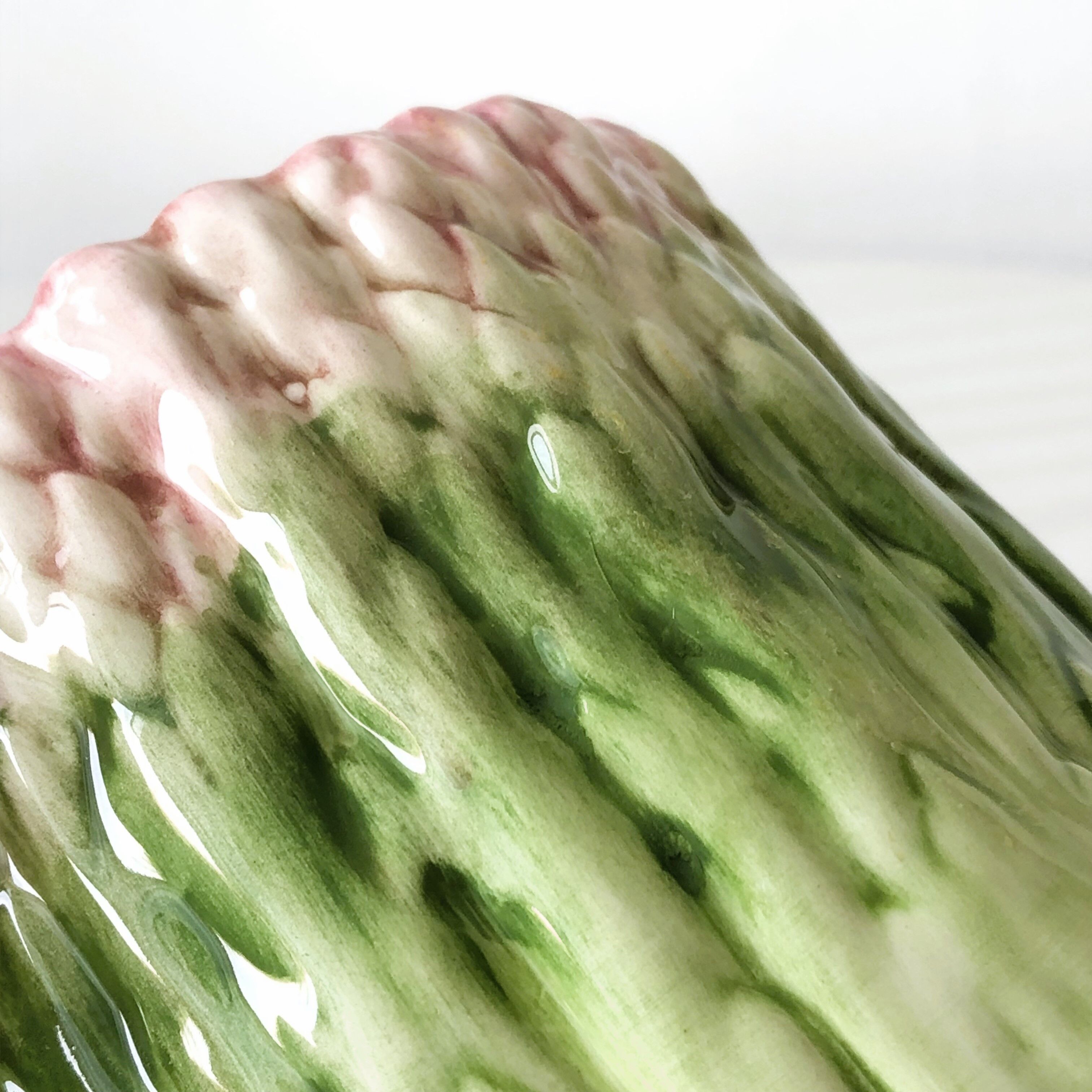 Old mustard pot and its slid in slurry decoration bunch of asparagus.