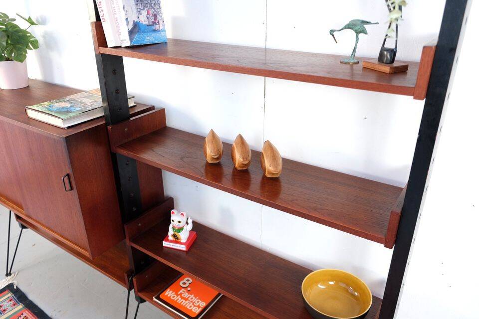 Vintage teak shelving system in 60s-70s style, retro style.