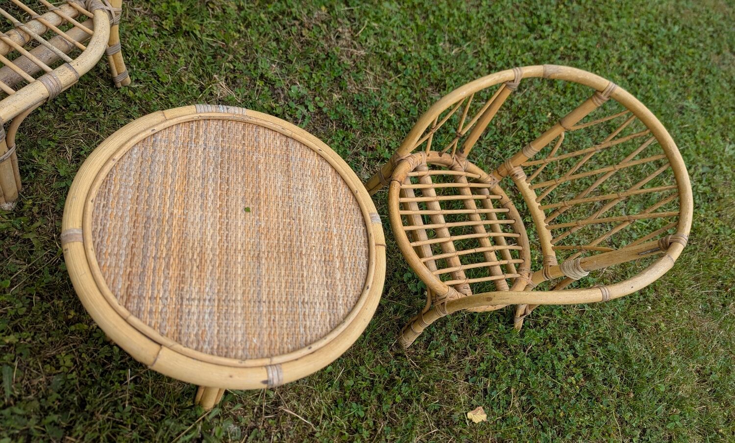 Set of children's rattan garden furniture from the 1950s and 1960s, including chairs, table, and bench.