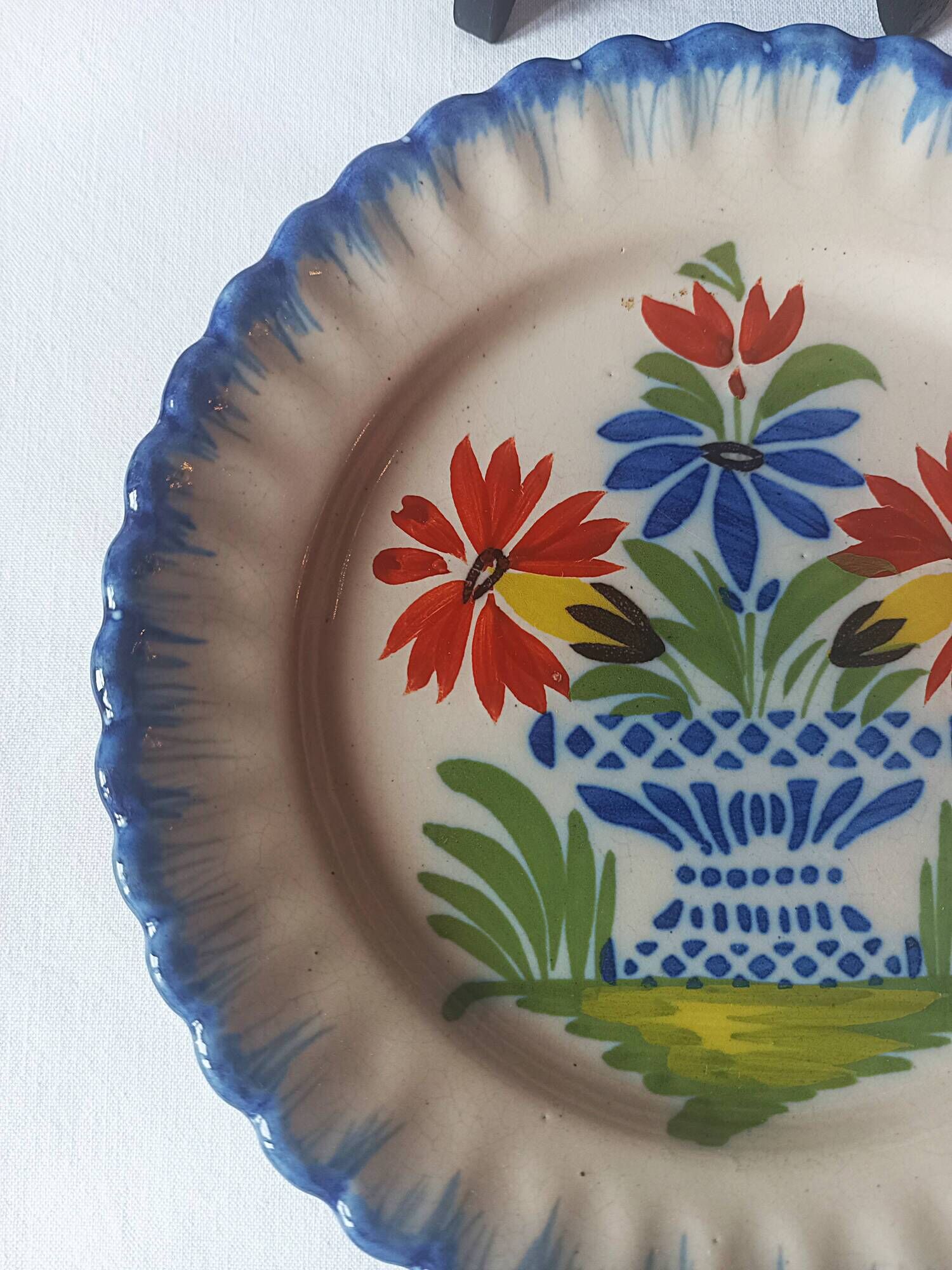 Pair of antique plates in popular earthenware with a floral basket decoration on the edge.