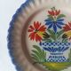 Pair of antique plates in popular earthenware with a floral basket decoration on the edge.