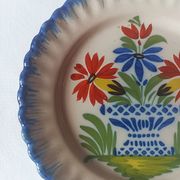 Pair of antique plates in popular earthenware with a floral basket decoration on the edge.