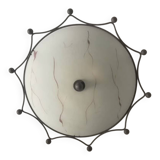 Round ceiling light with a wrought iron frame.