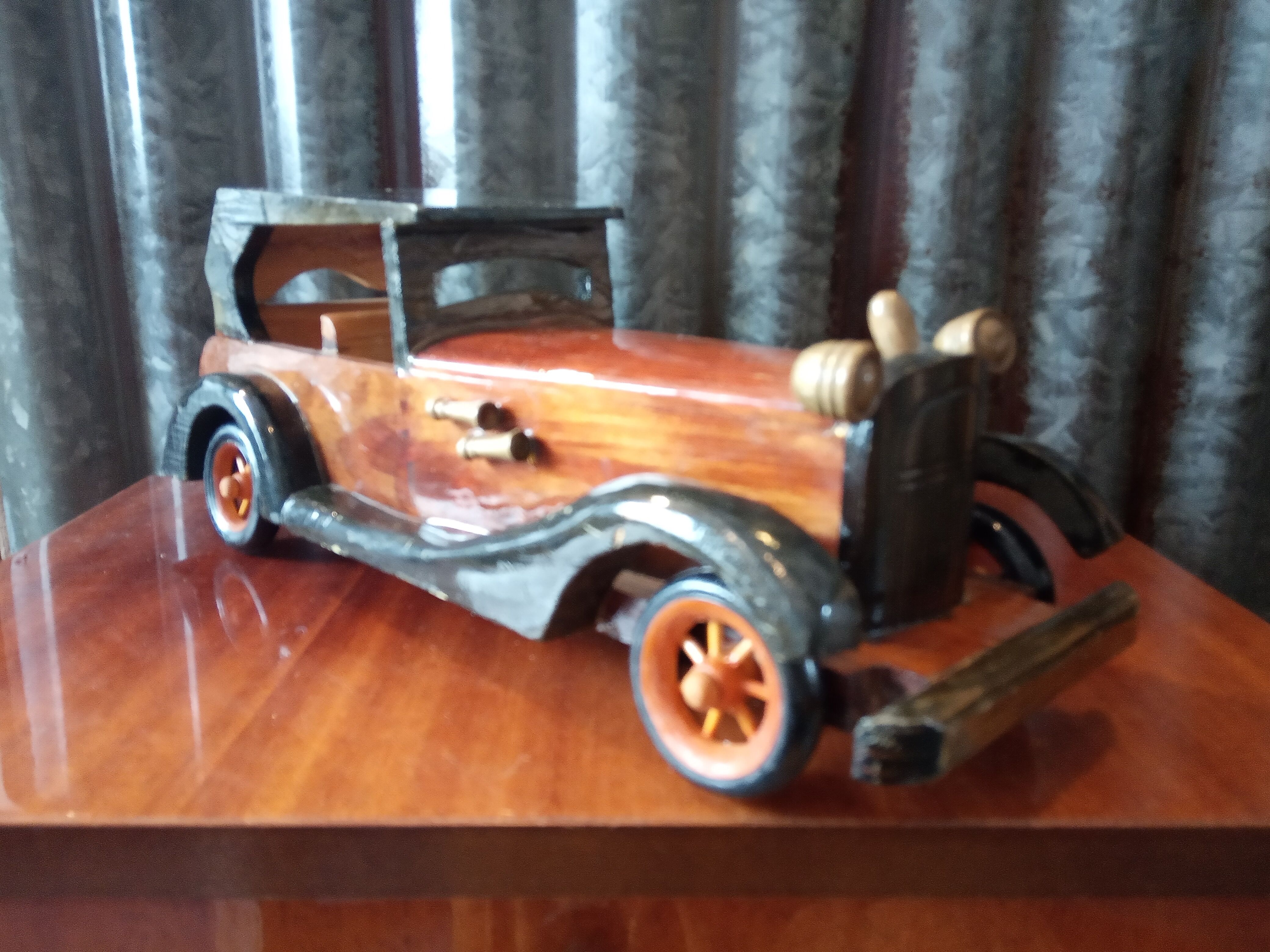 Toy car made of varnished wood