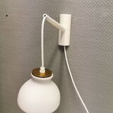 Milky white Holmegaard wall lamp with glass shade and a brass detail on top. Wooden wall bracket