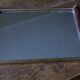 Rectangular mirror tray with wooden handles and gilding.