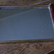 Rectangular mirror tray with wooden handles and gilding.