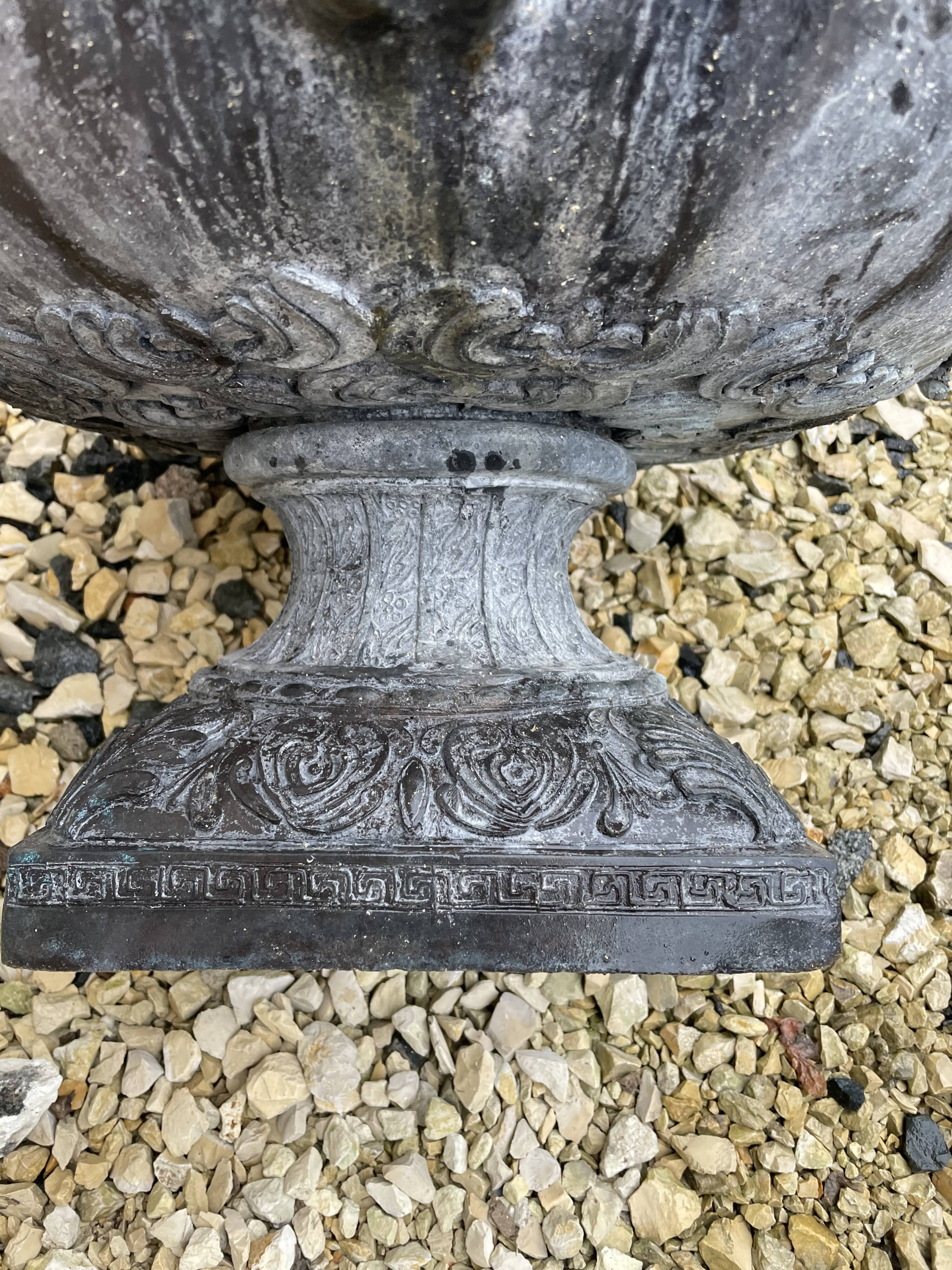 Cast iron vase decorated with mermaids.