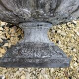 Cast iron vase decorated with mermaids.