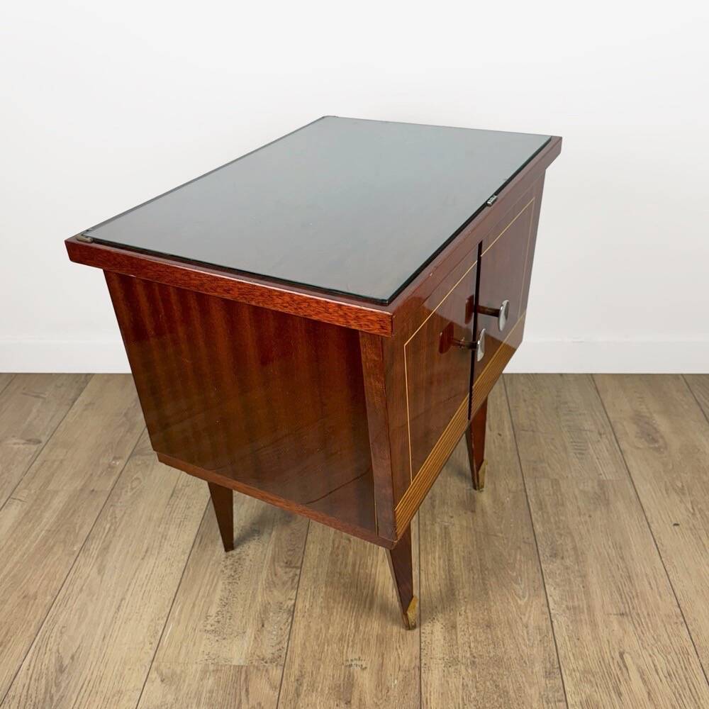 1950s bedside table in varnished wood veneer and brass.