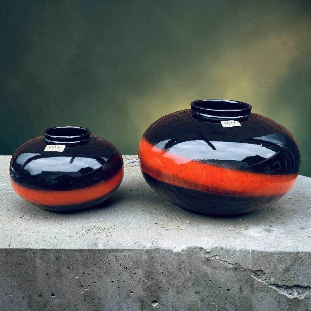A pair of black and red spherical vases by Bay Keramik, West Germany, from the 1960s.