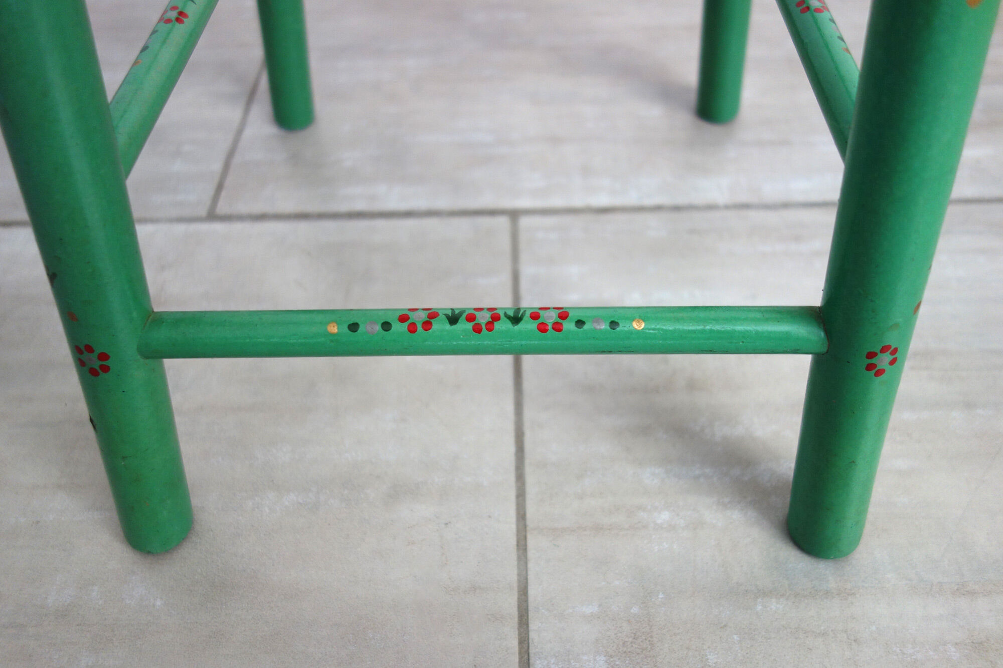 Old painted and decorated wooden stool