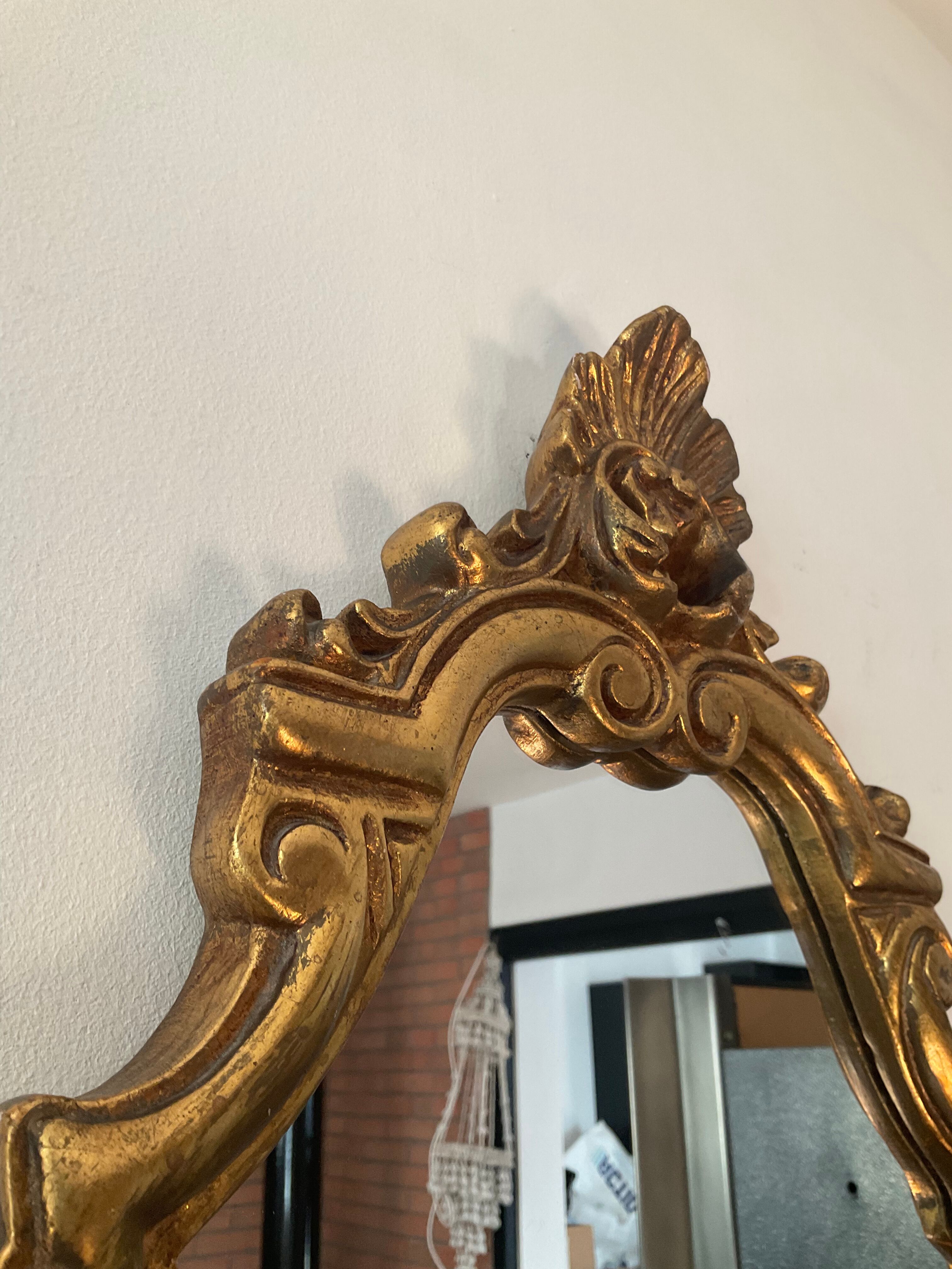 Old italian mirror in gilded plaster with leaf