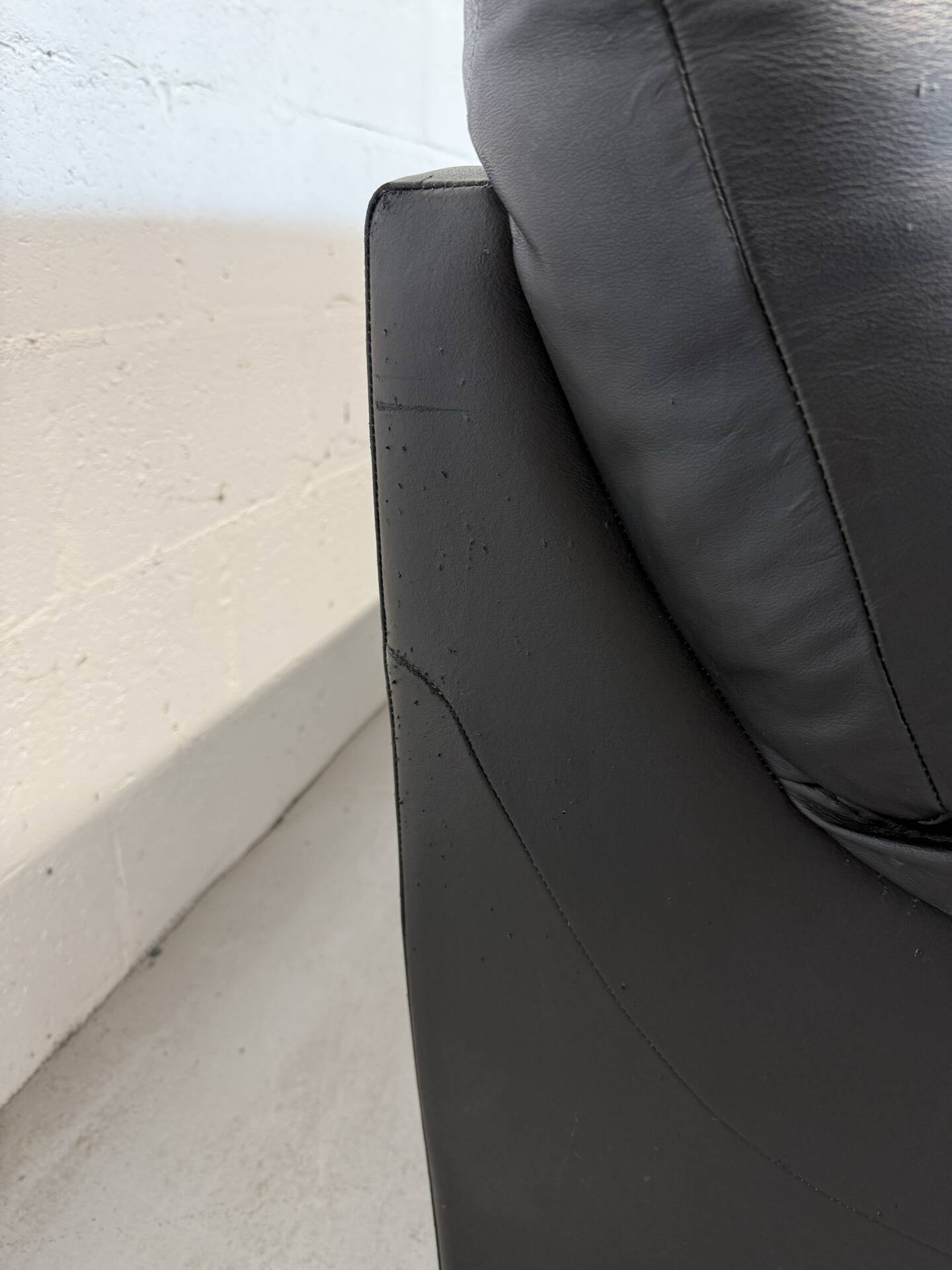 Two-seater black leather sofa — postmodern design