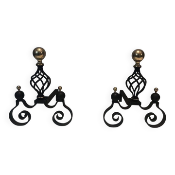 Pair of wrought iron and polished brass ball and cage body fire dogs.