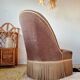 Brown velvet crapaud armchair with fringes and sculpted legs.