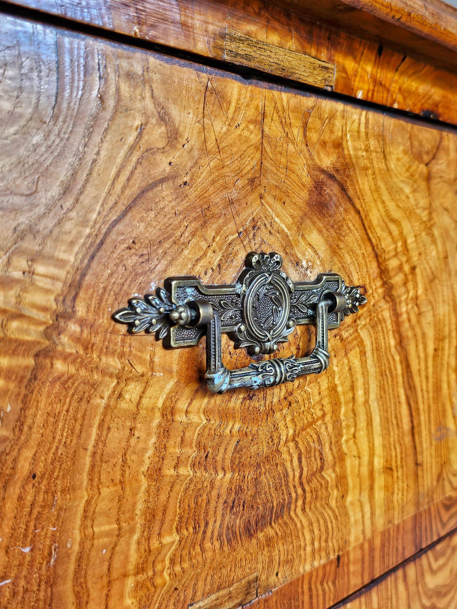 Large antique Biedermeier-style chest of drawers with wood grain.