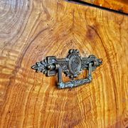 Large antique Biedermeier-style chest of drawers with wood grain.