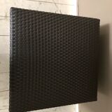 Pair of black synthetic rattan poufs from Flamant
