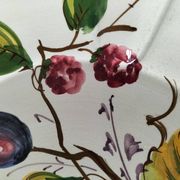 Set of three earthenware plates from Bassano, hand-painted with fruit and flower designs.