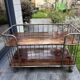 Industrial metal and wood serving trolley on wheels
