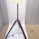Classic lampshade on antique surveyor tripod