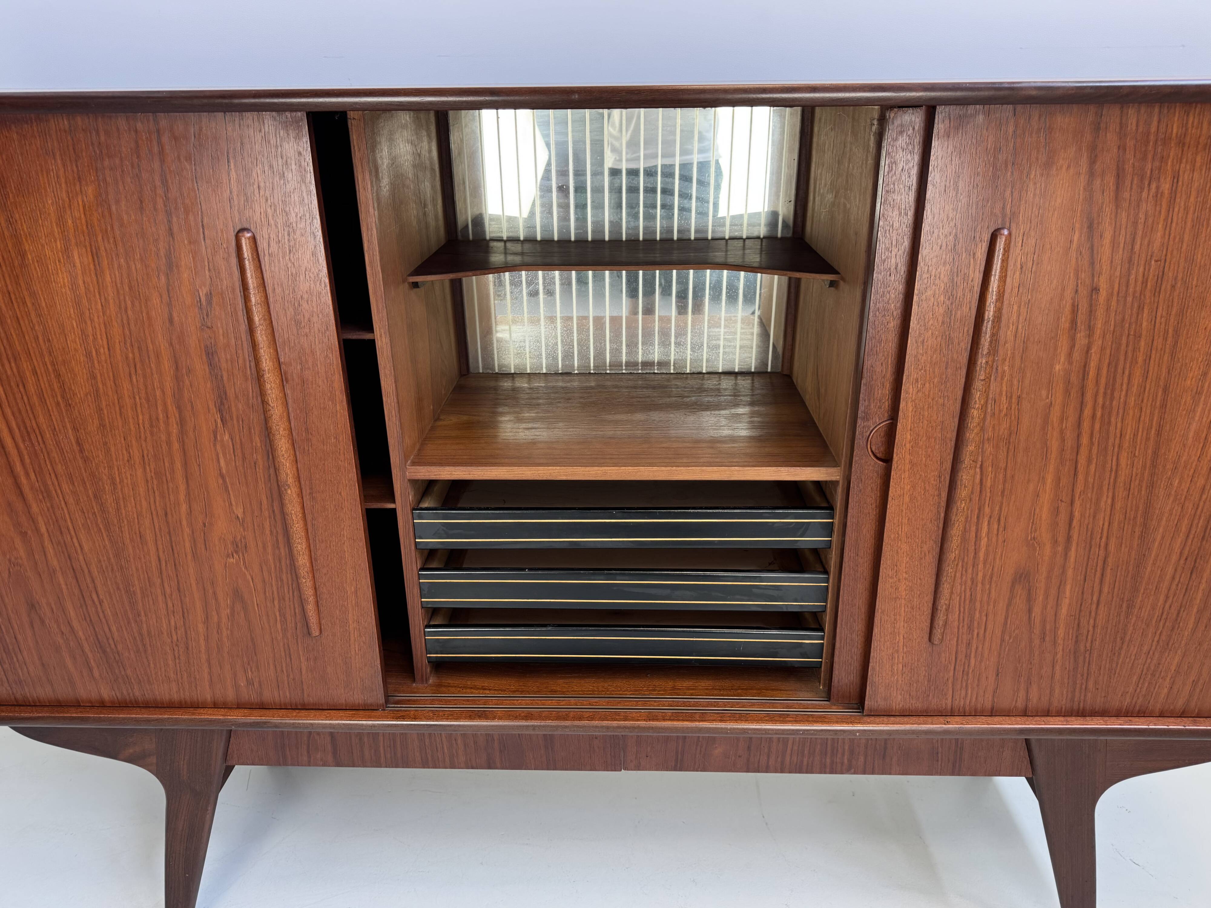 Vintage Danish teak wall unit with sliding doors from the 1960s.