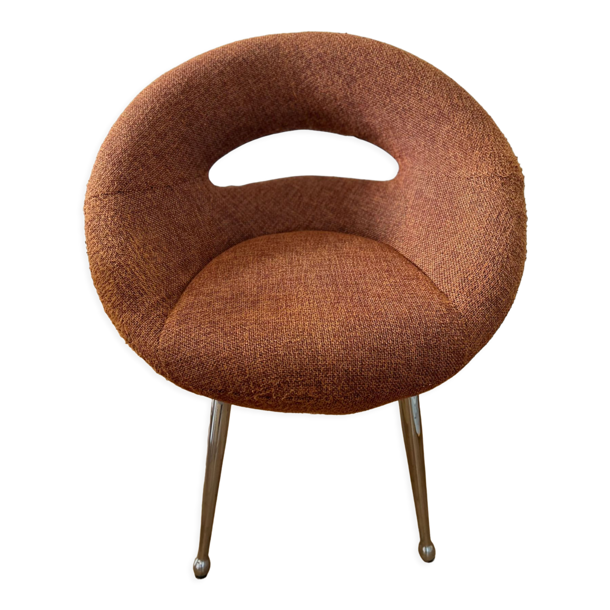Circular armchair trimmed with orange fabric