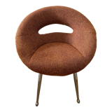 Circular armchair trimmed with orange fabric