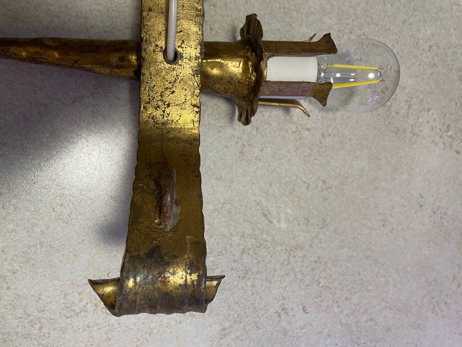 Spanish brutalist wall light in gilded wrought iron.