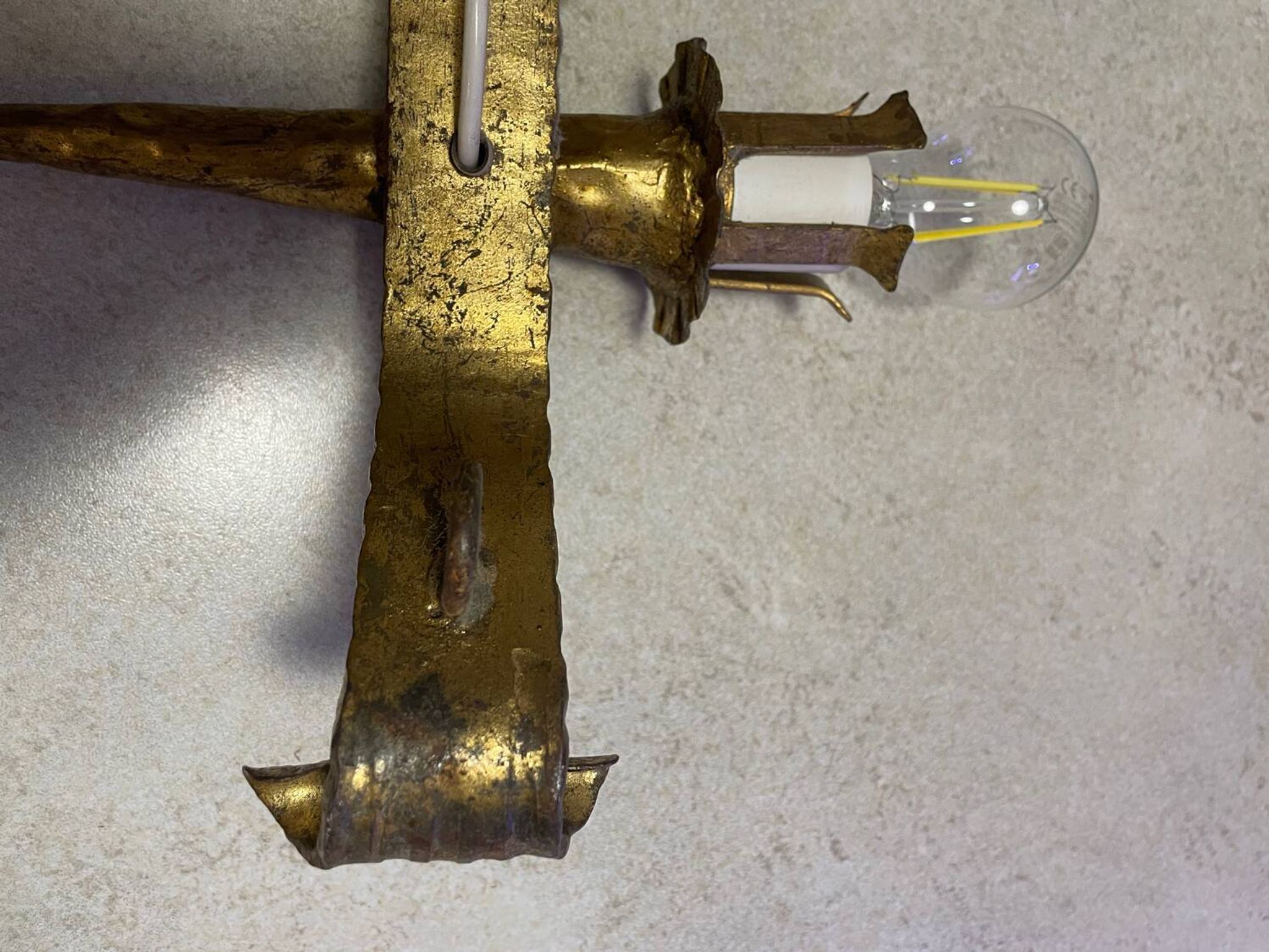 Spanish brutalist wall light in gilded wrought iron.