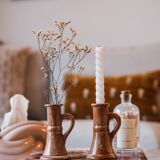 Set of two terracotta candle holders.