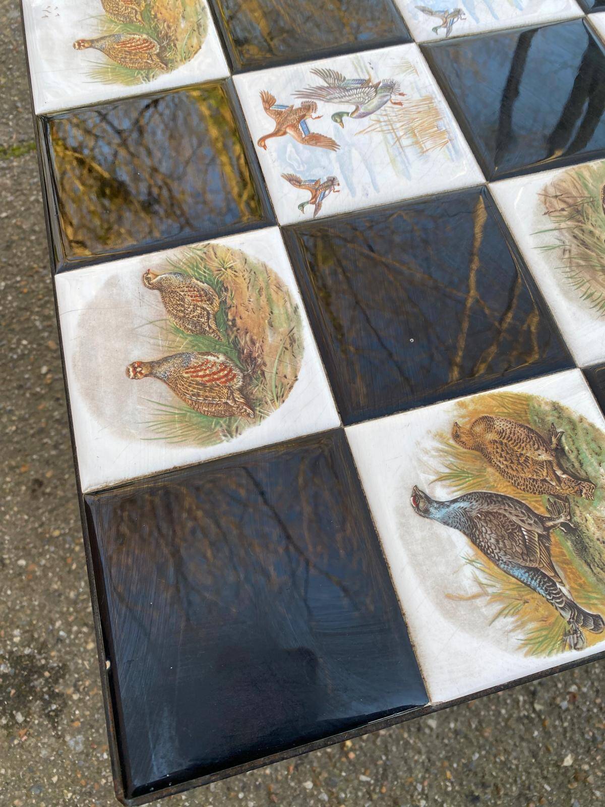 Vintage coffee table with black wrought iron and white tiles.