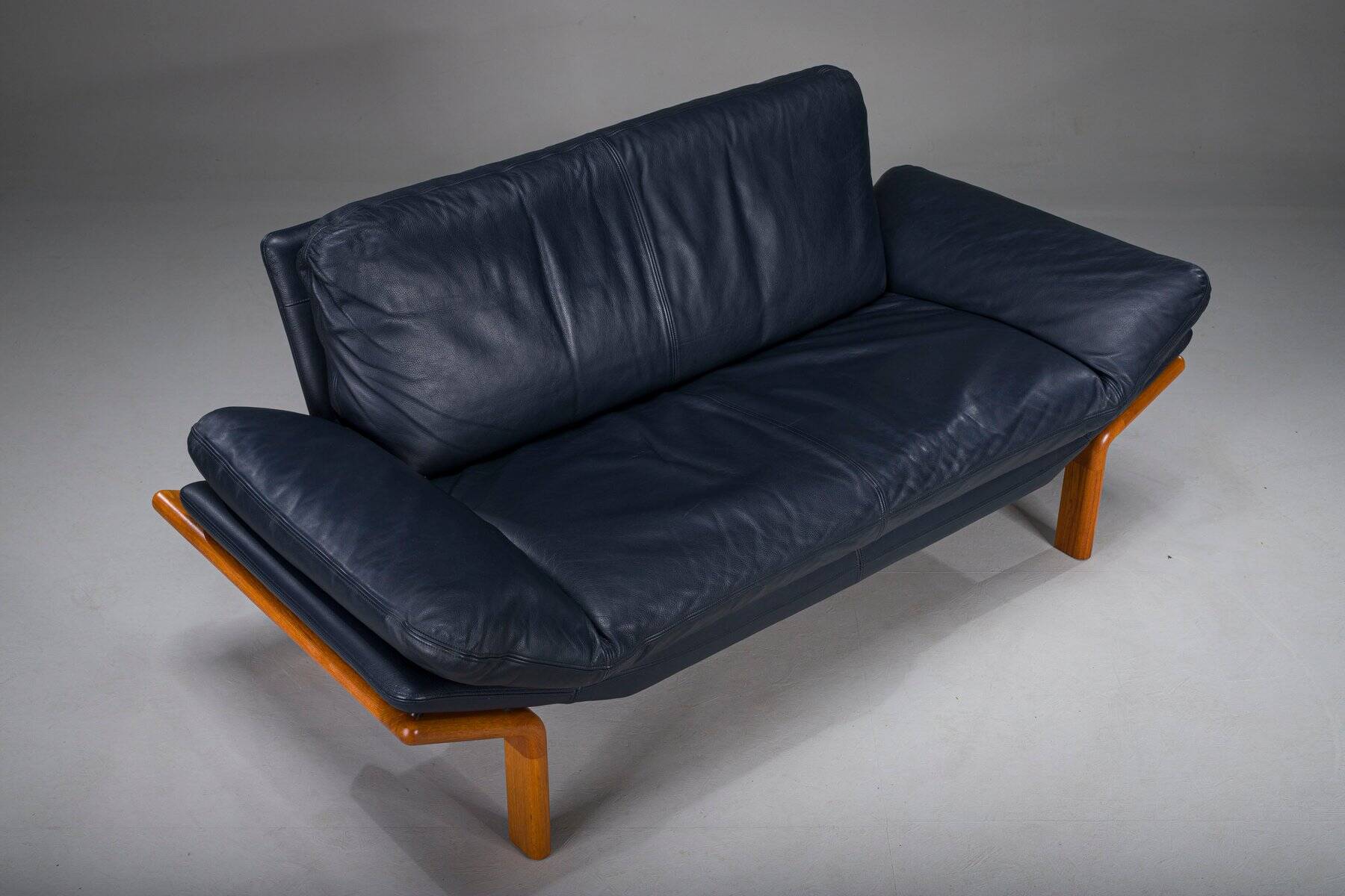 Danish teak and navy blue leather 2-seater sofa from Komfort, 1970s