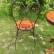 Round table and wrought iron chair