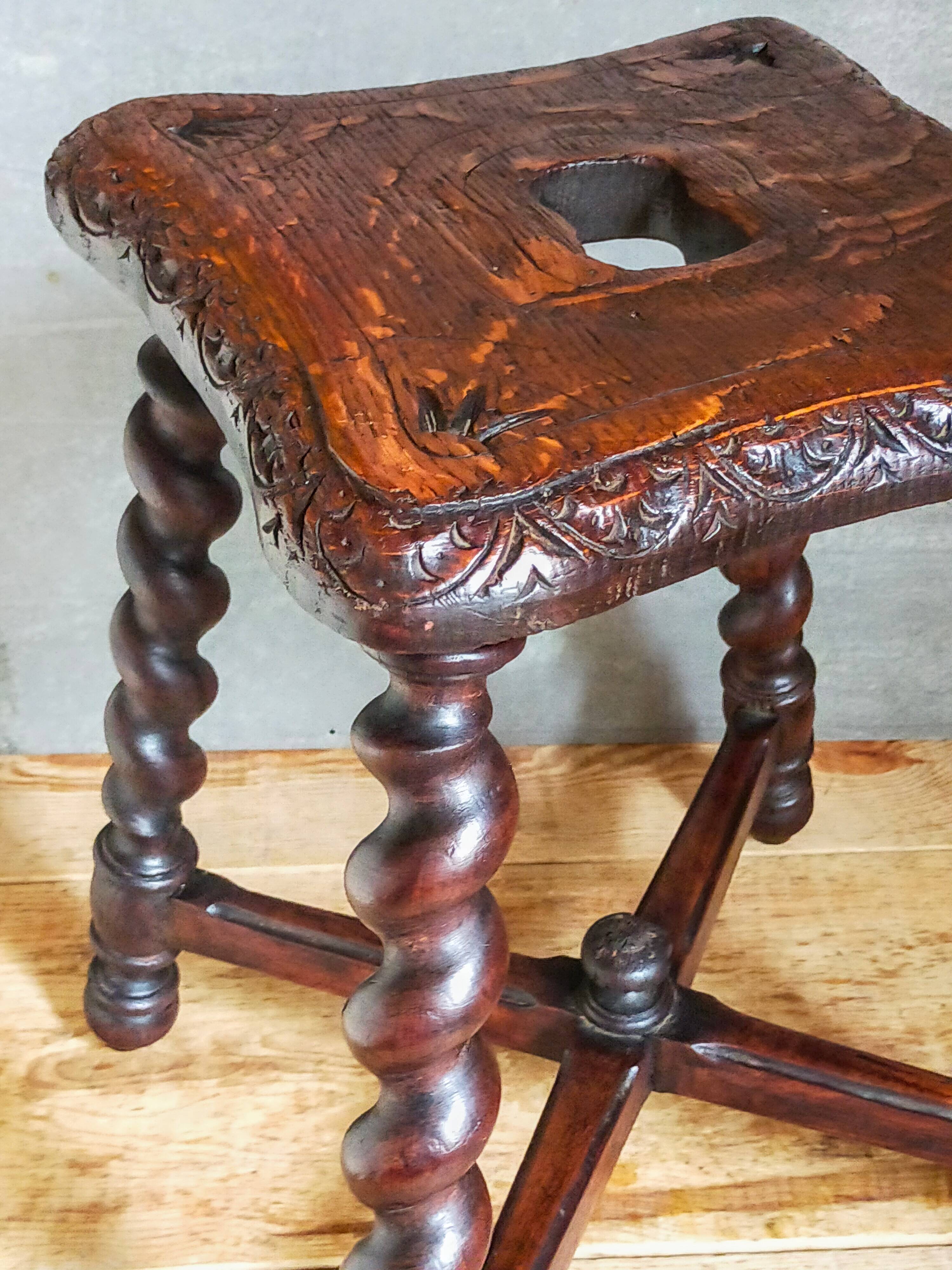 Antique stool in turned and carved solid wood