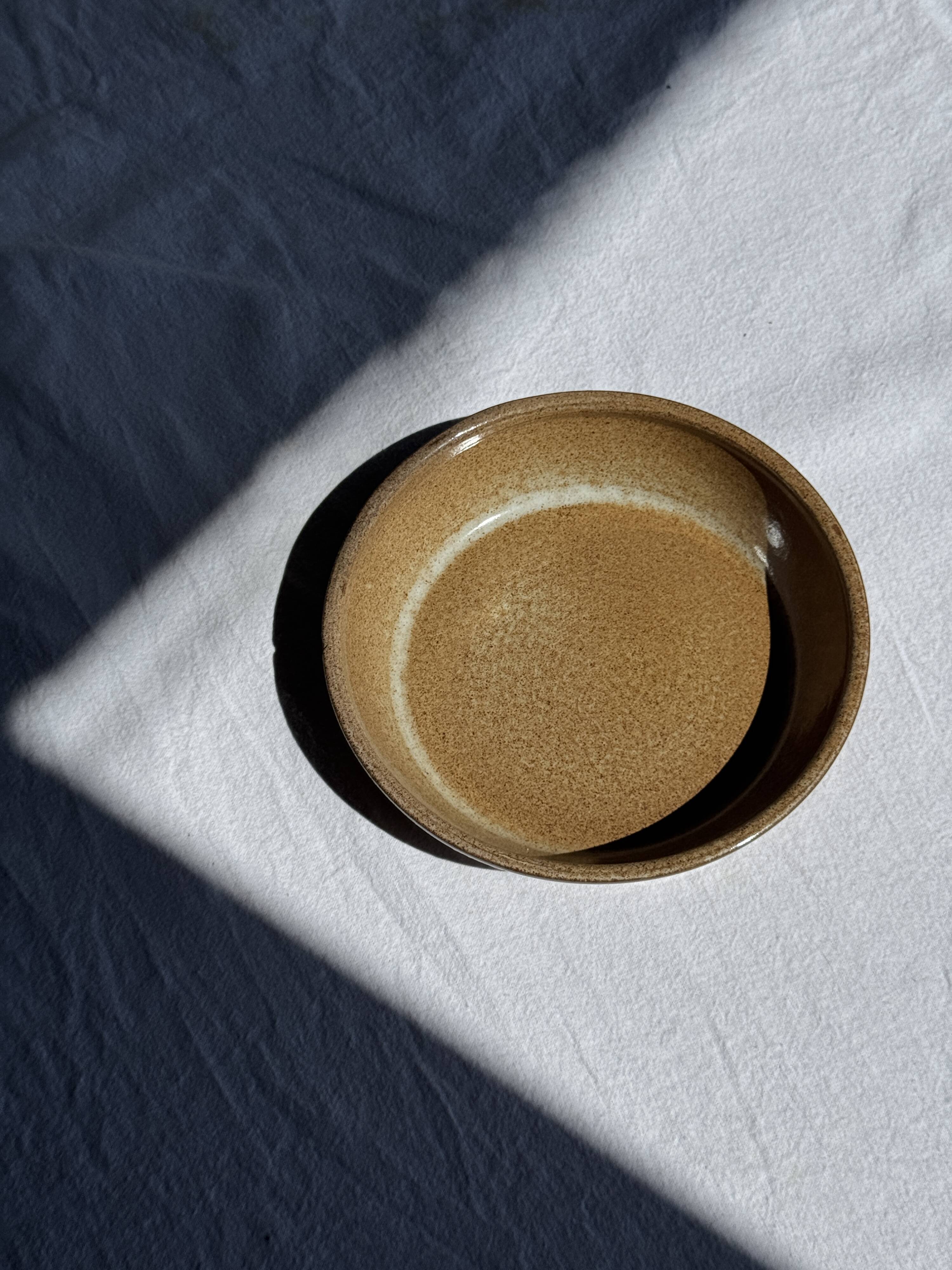A solid brown flat-bottomed stoneware bowl D18
