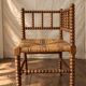 Corner chair in straw and turned wood, fireside chair.