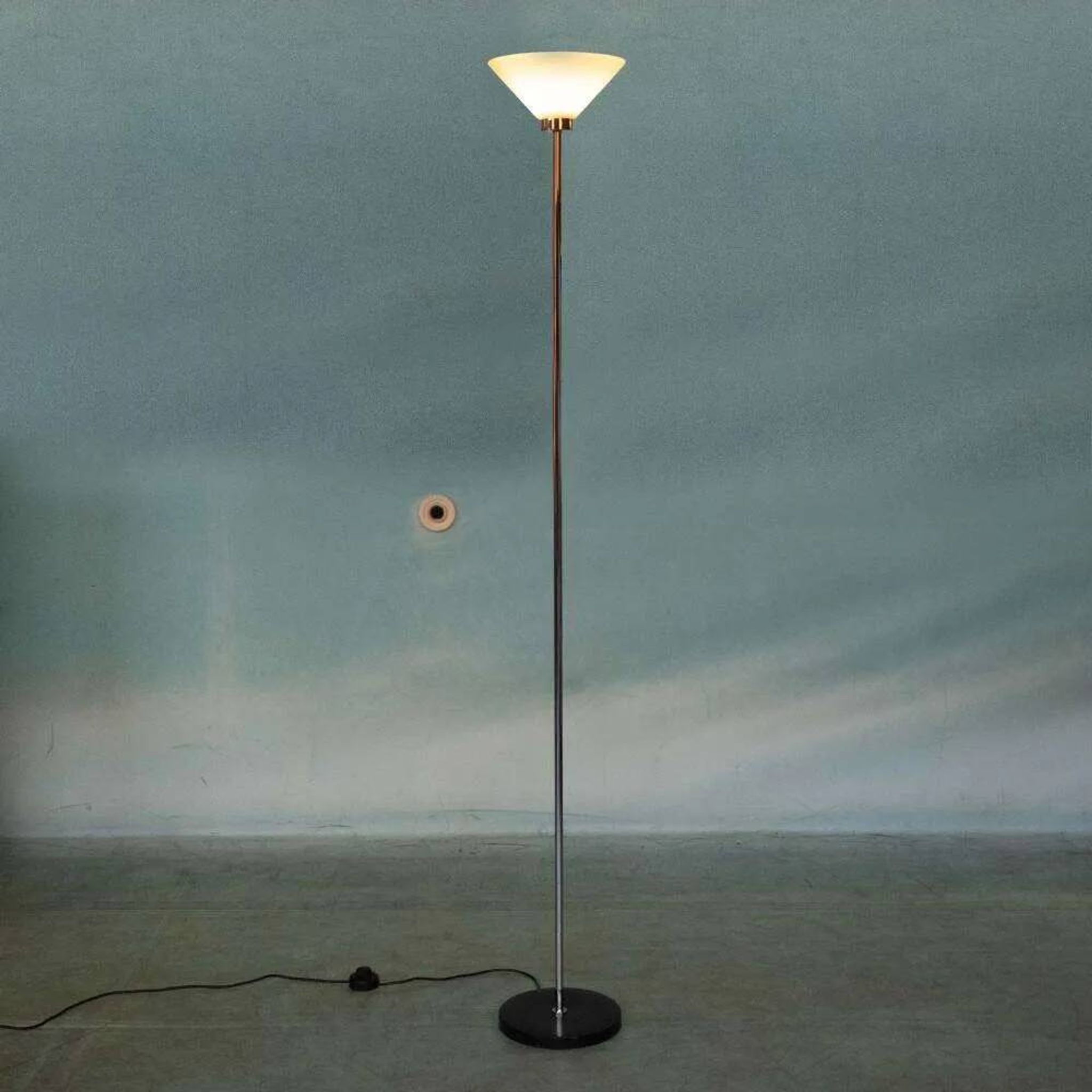 Vintage floor lamp in milky glass and chrome, minimalist uplight lighting.