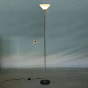 Vintage floor lamp in milky glass and chrome, minimalist uplight lighting.