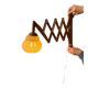 Vintage wall lamp with teak wood scissors and glass shade.