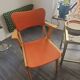 Modernist armchair in wood and orange fabric