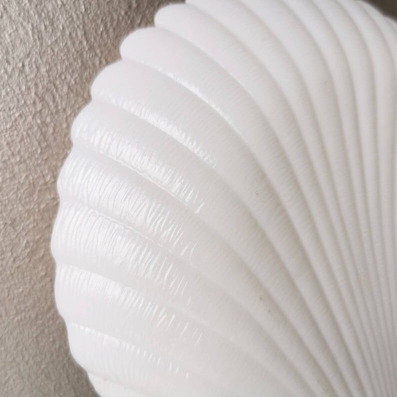 White ceramic dish shaped like 80s shells