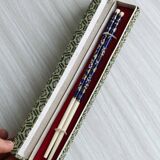 Blue chopsticks decorated with floral motifs.