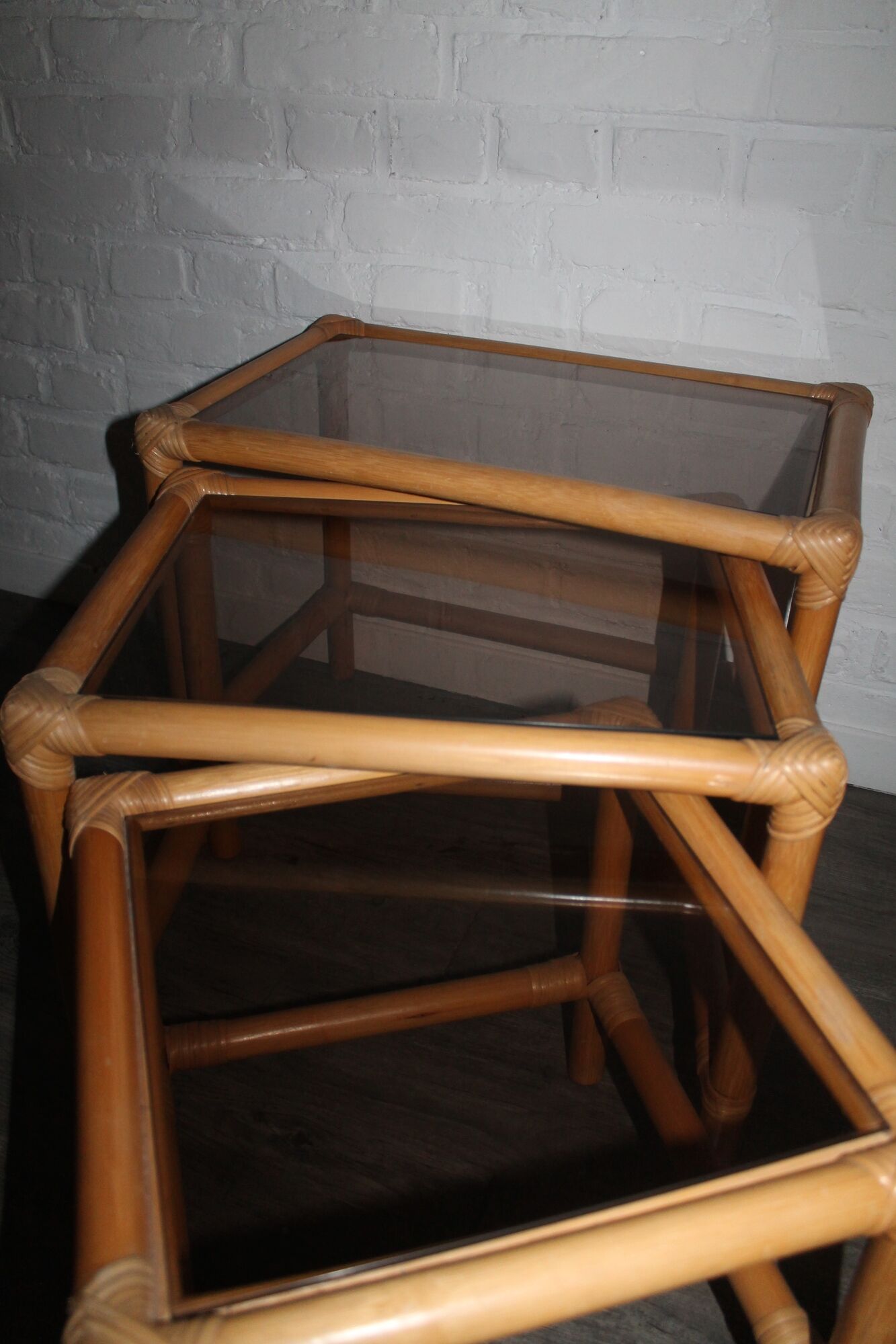 Rattan nesting tables in rattan and smoked glass from the 70s
