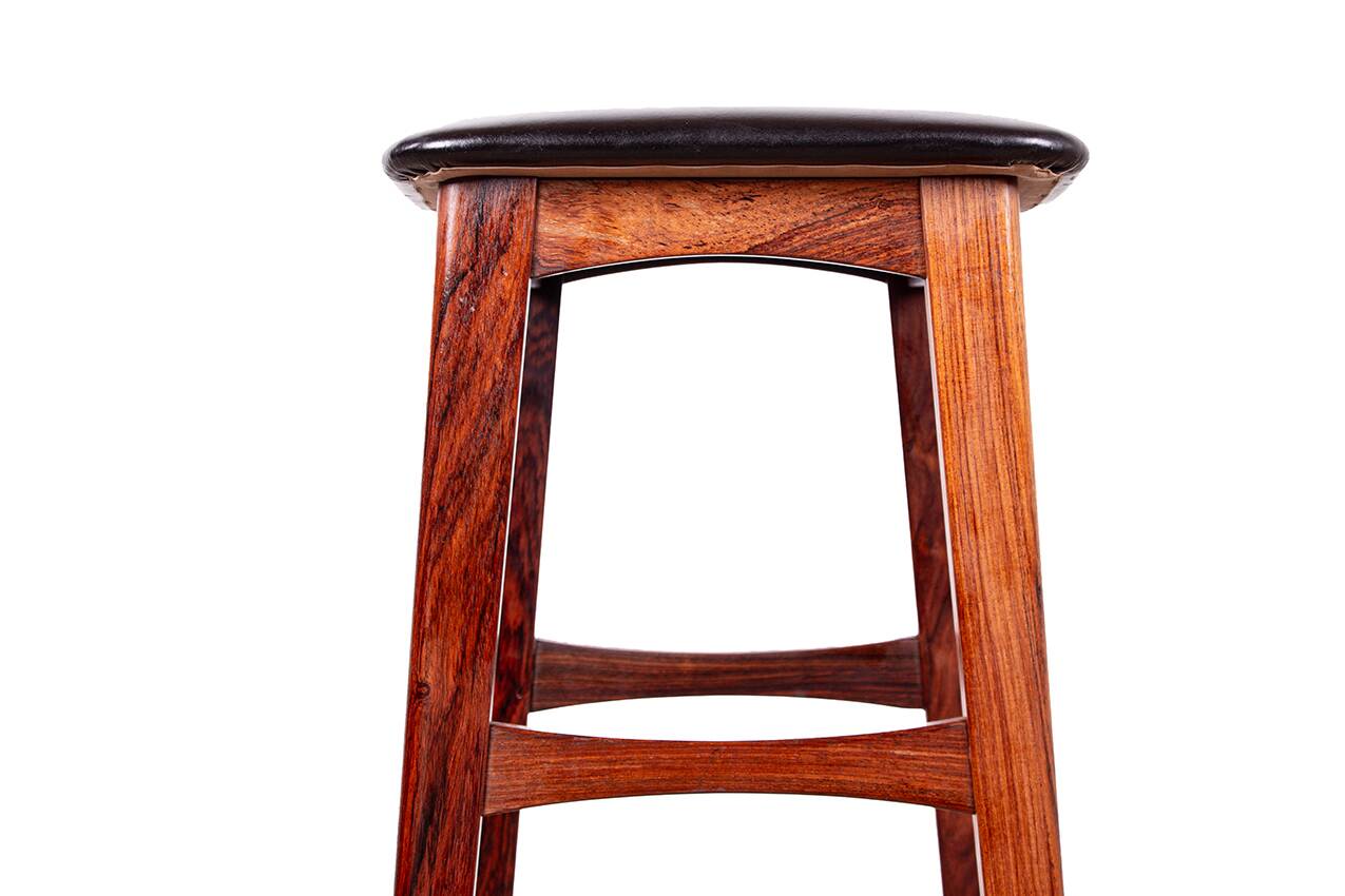 4 Danish high stools, rosewood and black leather, Knud Bent for Dyrlund.