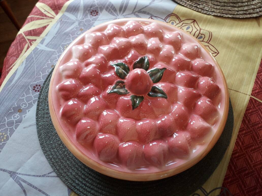 Glazed ceramic dessert plate with strawberry design.