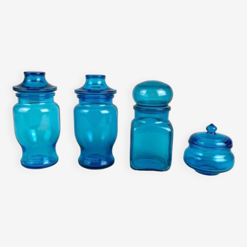 4 advertising jars in molded blue glass from the 70s